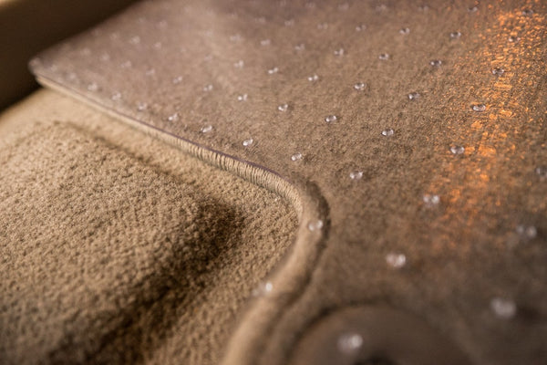 Zoomed in photo showing ExactMat being the exact size and shape of vehicle carpet mat. Highlight