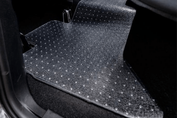 Clear Exactmat uni-mat placed on rear passenger floor mat. Highlight