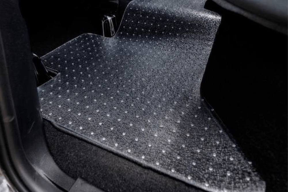 Clear Exactmat uni-mat placed on rear passenger floor mat. Highlight